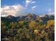 Scenic mountain landscape with vibrant desert vegetation and a clear blue sky filled with fluffy white clouds at 11617 E Raintree Dr, Scottsdale, AZ 85255