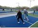 People enjoying pickle ball on outdoor court with clear marking and bright lighting system at 11617 E Raintree Dr, Scottsdale, AZ 85255