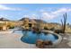 Beautiful backyard featuring a pool, rock waterfall, desert landscaping, and a mountain view at 11617 E Raintree Dr, Scottsdale, AZ 85255
