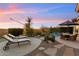 Beautiful pool with a patio area, lounge chairs, mature desert plants, and mountain views at 11617 E Raintree Dr, Scottsdale, AZ 85255