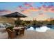 Inviting backyard pool and patio area with a relaxing water feature and comfortable outdoor seating, perfect for entertaining at 11617 E Raintree Dr, Scottsdale, AZ 85255