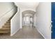 The entrance hallway features stairs, tile floors, and an arched opening leading to the living area at 1170 E Taylor Trl, San Tan Valley, AZ 85143