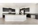 A kitchen featuring dark cabinets, stainless steel appliances, granite countertops, and a large island with seating at 1170 E Taylor Trl, San Tan Valley, AZ 85143