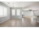A bright living room with tile flooring and multiple windows with plantation shutters allowing ample sunlight at 1170 E Taylor Trl, San Tan Valley, AZ 85143