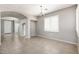 A bright living room with tile flooring, neutral walls, a chandelier, and a door to another room at 1170 E Taylor Trl, San Tan Valley, AZ 85143