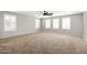 Spacious living room with carpet, neutral paint, and white window shutters at 1170 E Taylor Trl, San Tan Valley, AZ 85143