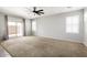 Spacious living room with ceiling fan, neutral paint, carpet, and access to the backyard at 1170 E Taylor Trl, San Tan Valley, AZ 85143