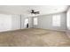 Spacious living room with carpet, neutral paint, and white window shutters at 1170 E Taylor Trl, San Tan Valley, AZ 85143