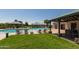 Inviting community swimming pool with lounge seating, cabanas, and manicured green grass at 1170 E Taylor Trl, San Tan Valley, AZ 85143