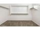 Walk-in closet with carpeted floor and white wall-mounted shelving system at 1170 E Taylor Trl, San Tan Valley, AZ 85143