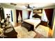 Bedroom featuring a bed with padded headboard, dark wood furniture, and ensuite access at 12008 W Acapulco Dr, El Mirage, AZ 85335