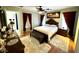 Bedroom featuring a bed with padded headboard, dark wood furniture, and ensuite access at 12008 W Acapulco Dr, El Mirage, AZ 85335