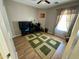 Bedroom with laminate flooring, ceiling fan, and decorative green and beige area rug at 12008 W Acapulco Dr, El Mirage, AZ 85335