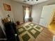 Bedroom with laminate flooring, ceiling fan, and decorative green and beige area rug at 12008 W Acapulco Dr, El Mirage, AZ 85335