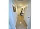 Hallway with tile flooring, art decorations, and a decorative console table at 12008 W Acapulco Dr, El Mirage, AZ 85335