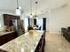 Spacious kitchen island with bar seating overlooks the bright dining area and living spaces at 12008 W Acapulco Dr, El Mirage, AZ 85335