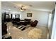 Expansive living room featuring tile floors, recessed lighting, and plush leather furniture at 12008 W Acapulco Dr, El Mirage, AZ 85335
