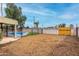 Large backyard with a pool behind a fence and separate mulch covered area at 1226 E Fairmont Dr, Tempe, AZ 85282