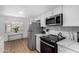 Modern kitchen with white cabinets, stainless steel appliances, and an open design at 1226 E Fairmont Dr, Tempe, AZ 85282