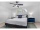 Well-lit bedroom with a large bed, blue accents, and plush carpeting at 1226 E Fairmont Dr, Tempe, AZ 85282