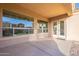 Covered back patio with large windows providing a view of the backyard and access from inside the home at 15993 W Poinsettia Dr, Surprise, AZ 85379