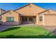 Spacious backyard featuring low-maintenance desert landscaping and a perfectly sized artificial grass area at 15993 W Poinsettia Dr, Surprise, AZ 85379