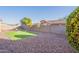 Backyard featuring low-maintenance desert landscaping, artificial grass and block wall fencing at 15993 W Poinsettia Dr, Surprise, AZ 85379