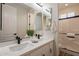 Bright bathroom with a double sink vanity, quartz countertops, matte black hardware and a shower/tub combo at 15993 W Poinsettia Dr, Surprise, AZ 85379