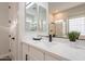 Bathroom counter featuring white countertop, black faucet and fixtures and a large mirror at 15993 W Poinsettia Dr, Surprise, AZ 85379