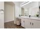 Bathroom vanity with lots of lighting, a large mirror, and a stool at 15993 W Poinsettia Dr, Surprise, AZ 85379
