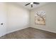 Empty bedroom with hardwood flooring and large window providing natural light at 15993 W Poinsettia Dr, Surprise, AZ 85379