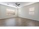 Spacious bedroom features hardwood floors and ample natural light from multiple windows at 15993 W Poinsettia Dr, Surprise, AZ 85379