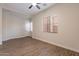 Empty bonus room showcasing wood look flooring and a large window at 15993 W Poinsettia Dr, Surprise, AZ 85379
