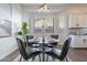 Cozy dining area with gray chairs, bay windows, and stylish decor at 15993 W Poinsettia Dr, Surprise, AZ 85379