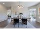 Open dining room with natural light, modern table, and an open concept layout at 15993 W Poinsettia Dr, Surprise, AZ 85379