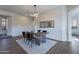 Bright dining room with modern decor, and a light fixture at 15993 W Poinsettia Dr, Surprise, AZ 85379