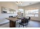 Dining room with an open layout, modern table and seating, and lots of natural light at 15993 W Poinsettia Dr, Surprise, AZ 85379