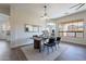 Elegant dining room with a modern table, stylish chandelier, and hardwood floors at 15993 W Poinsettia Dr, Surprise, AZ 85379