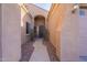 Covered entryway with a pathway, complemented by desert landscaping and a view of the front door at 15993 W Poinsettia Dr, Surprise, AZ 85379