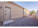 Side exterior view of home with a neutral color scheme and low-maintenance desert landscaping at 15993 W Poinsettia Dr, Surprise, AZ 85379