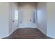 Bright foyer with wood flooring and a white door flanked by sidelight windows at 15993 W Poinsettia Dr, Surprise, AZ 85379