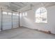 Spacious garage with an automatic door and plenty of room for storage, plus windows for natural light at 15993 W Poinsettia Dr, Surprise, AZ 85379