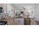 Open concept kitchen and living area with stainless steel appliances and island sink at 15993 W Poinsettia Dr, Surprise, AZ 85379