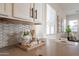 Modern kitchen features white cabinetry, stainless steel appliances and hexagon tile backsplash at 15993 W Poinsettia Dr, Surprise, AZ 85379