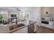 Open concept kitchen and living area with stainless steel appliances and island sink at 15993 W Poinsettia Dr, Surprise, AZ 85379