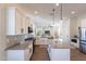 Large kitchen with island, stainless steel appliances, and open to living spaces at 15993 W Poinsettia Dr, Surprise, AZ 85379