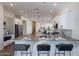 Modern kitchen with island seating, stainless appliances, and open floorplan at 15993 W Poinsettia Dr, Surprise, AZ 85379