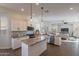 Spacious kitchen with large island, stainless steel appliances, and seamless living room integration at 15993 W Poinsettia Dr, Surprise, AZ 85379