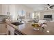 Open concept kitchen and living area with stainless steel appliances and island sink at 15993 W Poinsettia Dr, Surprise, AZ 85379