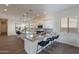 Bright kitchen with a large island, bar stool seating, and stainless steel appliances at 15993 W Poinsettia Dr, Surprise, AZ 85379